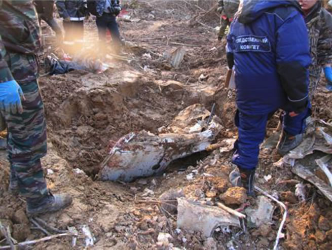 Figure 1. The left passenger door no.2 being dug out by hand from its penetration 1 meter into the deeper solid soil at the very beginning of the main crash site.