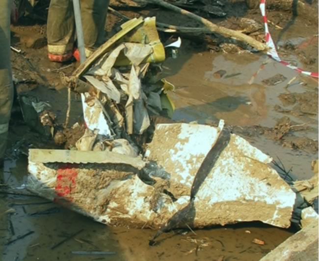 Shards of the upper part of the pilot's cabin lying in the mud in sector 8 at the crash site.