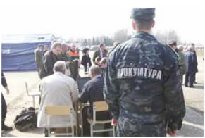 April 11, 2010, 15:51 p.m.  Identification of the remains of the victims of the Tu-154M aircraft on the tarmac. In the back of the frame, first on the right, is a Russian Special-Forces Colonel.