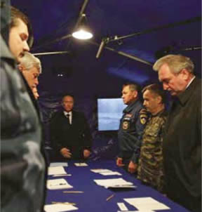 April 10, 2010, Smolensk, Crash Site: "Staff Briefing" in a tent. From the right: Sergei Antufiev - Governor of the Smolensk Oblast, Rashid Nurgaliyev - (Spetsnaz) Army General, Mikhail Osipienko, Supreme Commander of the RF Ministry for Extraordinary Emergencies, Smolensk District, and Vladimir Vladimirovich Putin - then Prime Minister of Russian Federation.